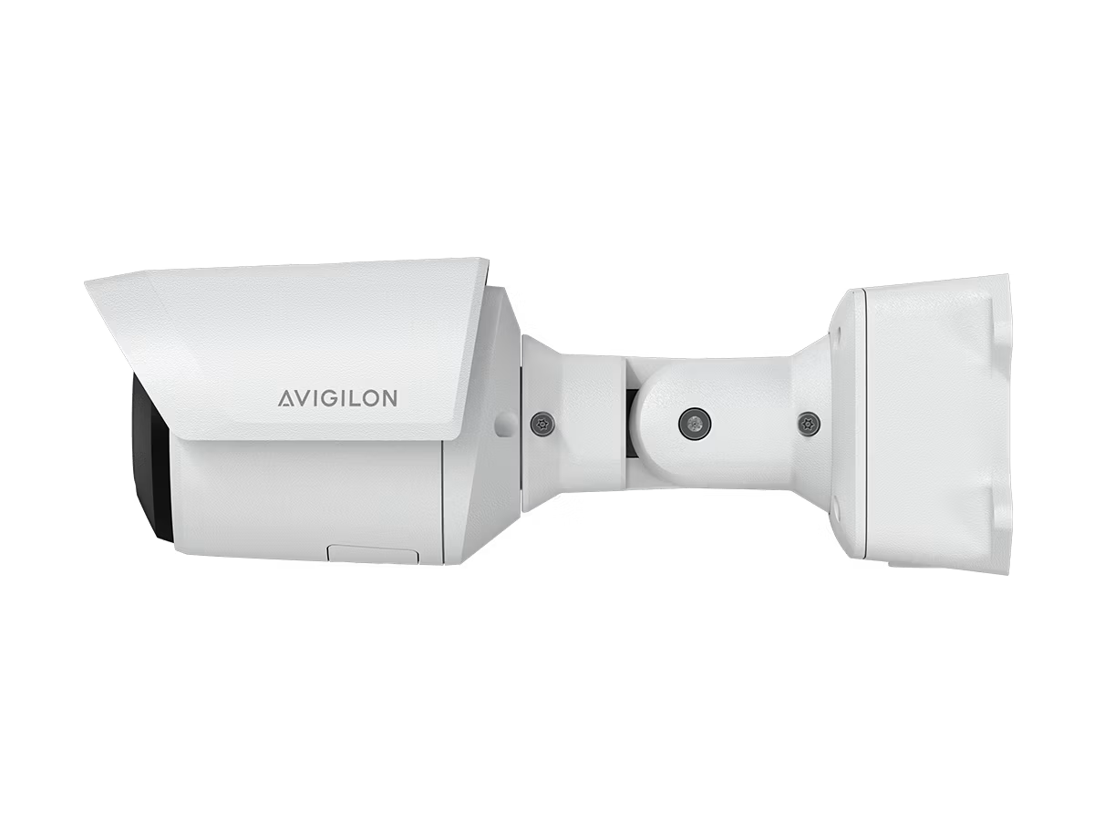 White surveillance camera side view. Rectangular housing, hinged arm.