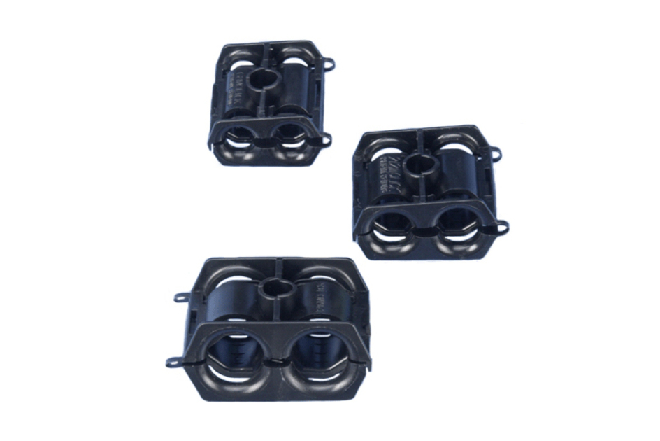 Three black plastic holders with openings and clips.