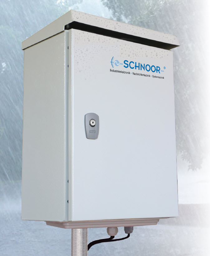 Gray electrical cabinet with lock and company logo outdoors.