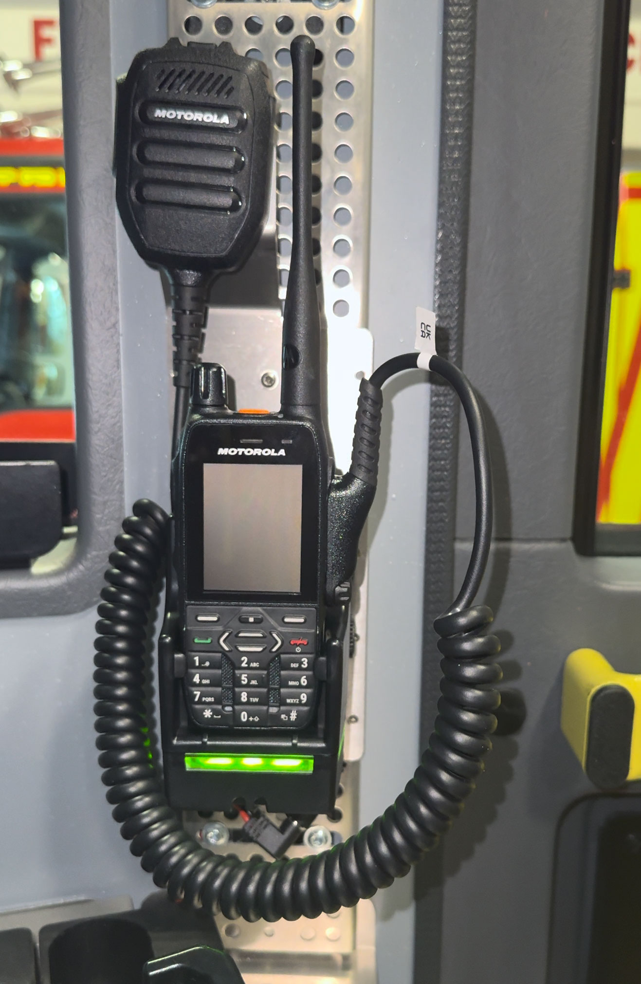 Radiotoestel met microfoonhouder in een voertuig gemonteerd.