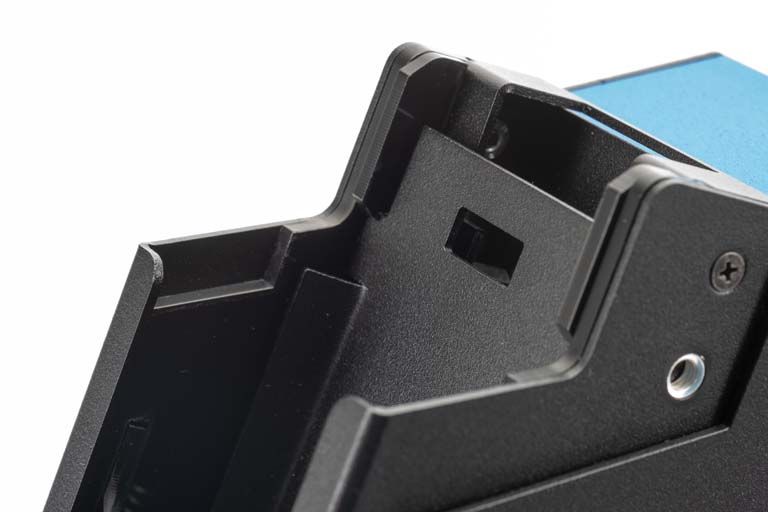 Black plastic case, partially open, with screw holes.