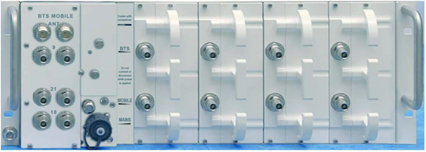 A modular electronic device with multiple connectors and switches on the front.