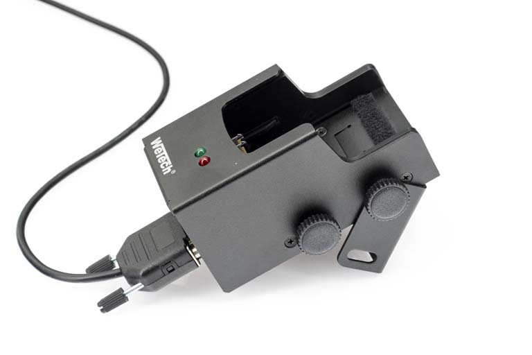 Black electronic device with cable, two knobs, and two status lights.