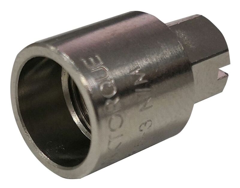 Metal adapter with hexagonal opening and engraving on edge.