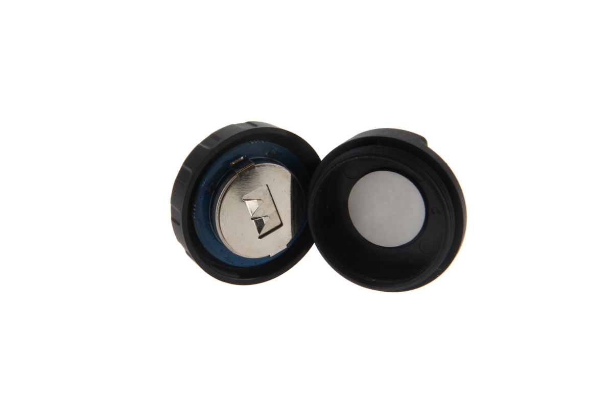 Open batterijcompartiment met zichtbare knoopcelbattery.