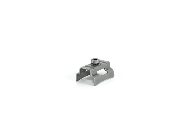 Metal clip with a screw in the middle, used for fastening.