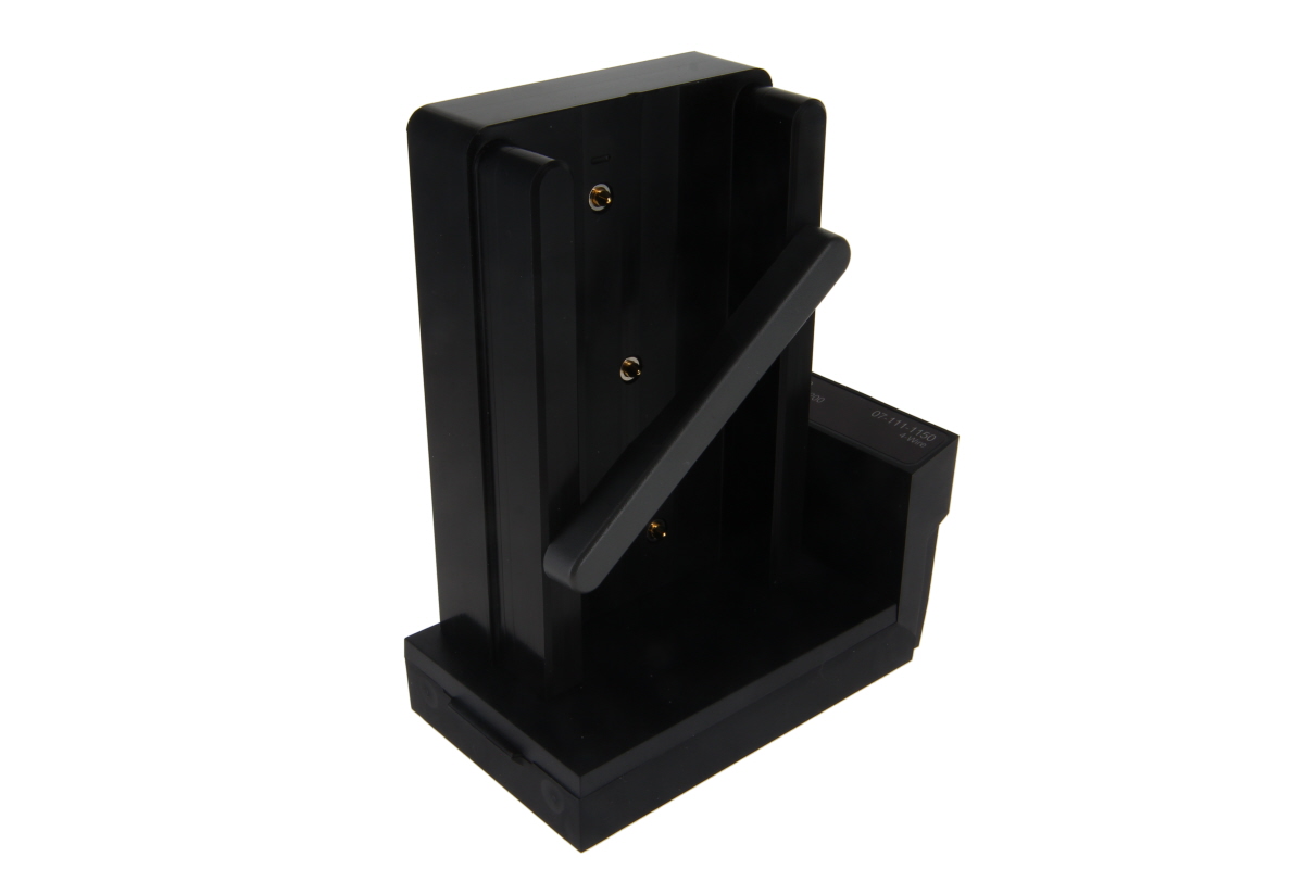 Black metal bracket with two slots and four screw holes.