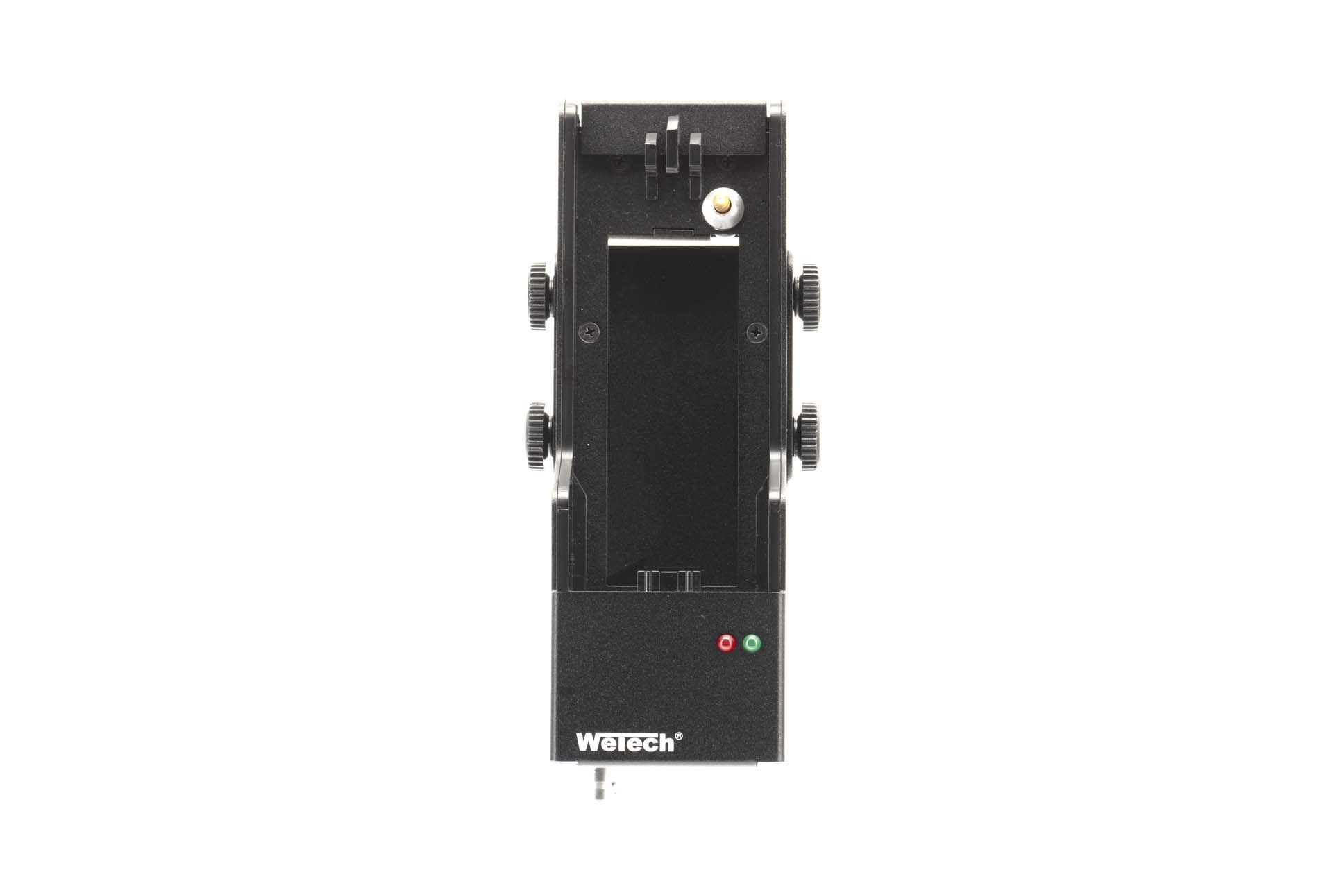 Black mechanical device with multiple knobs and a green and red light.