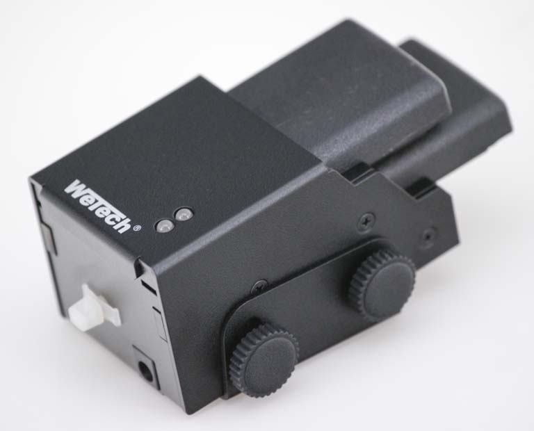 Black technical device with two adjustment knobs and white switch.