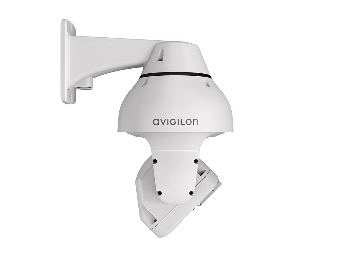 White security camera with wall mount, Avigilon logo visible.