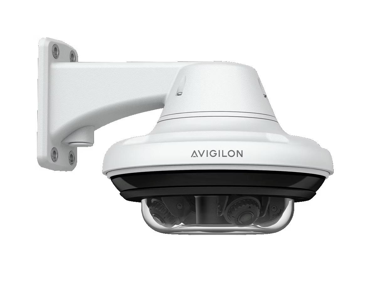 White surveillance camera on a wall mount.