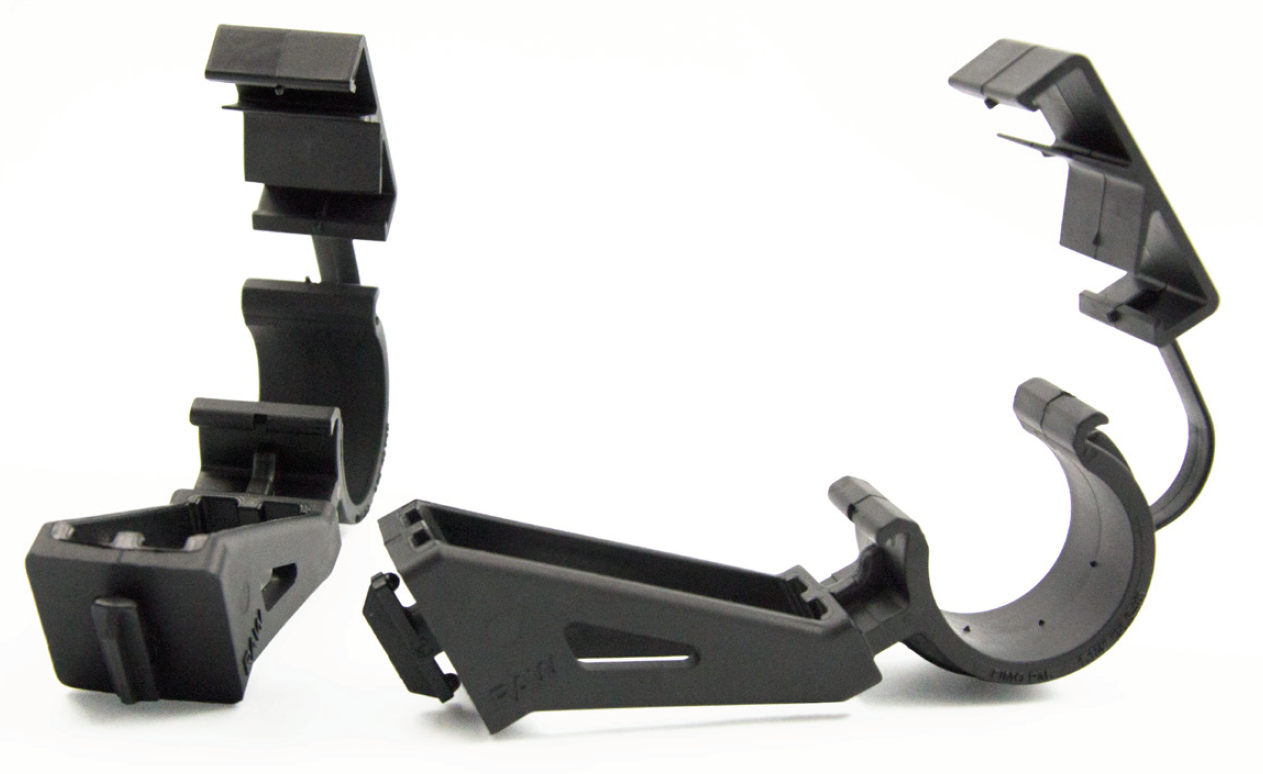 Two black plastic clamps with holder, open.