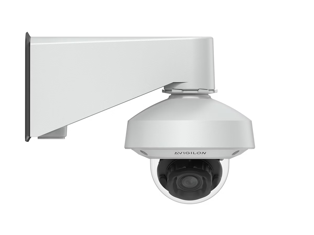White surveillance camera on wall mount.