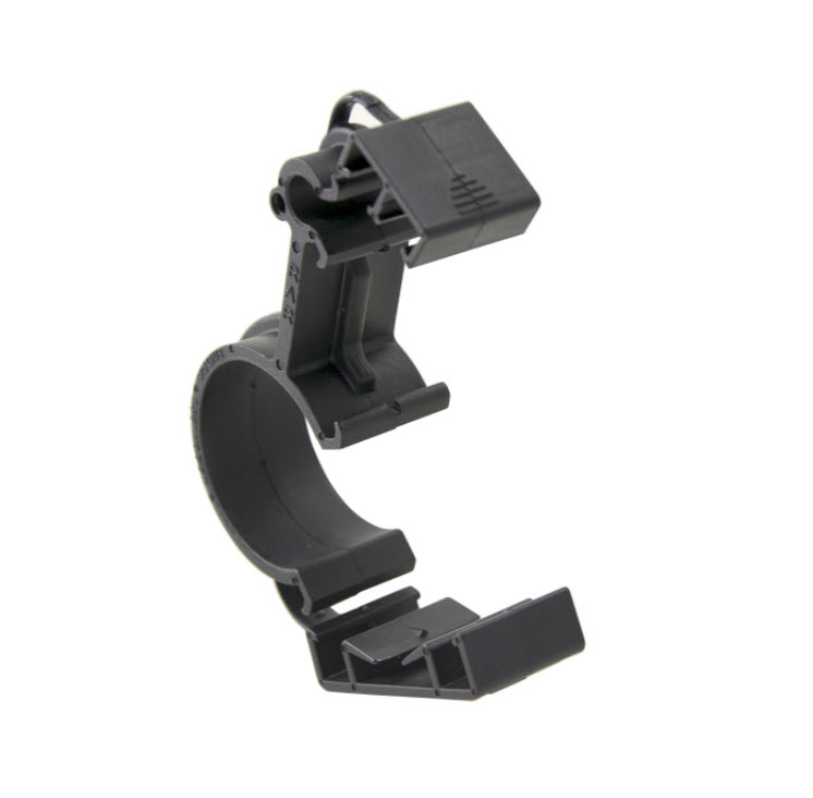 Black plastic clamp, curved for cable fastening.