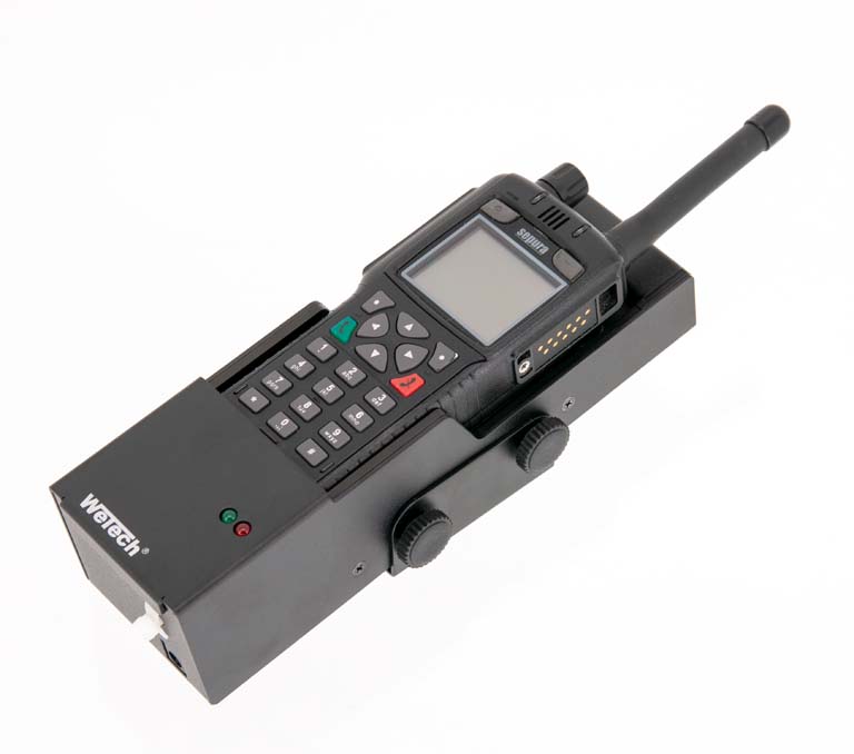Handheld radio with buttons on charging dock, antenna right.
