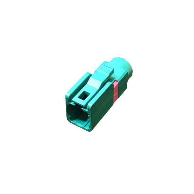 Connecteur en plastique vert rectangulaire à bande rouge.