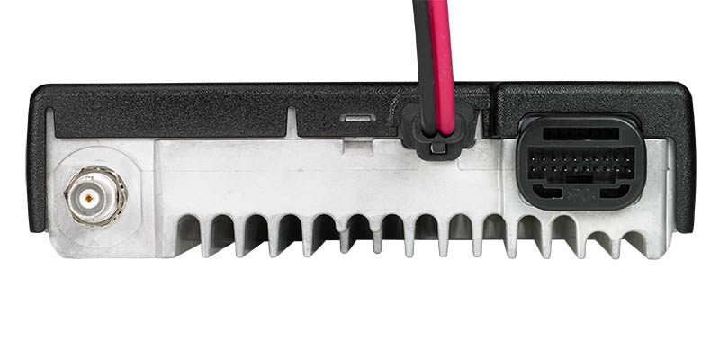 Rear of electronic device with cooling fins and cable connectors.