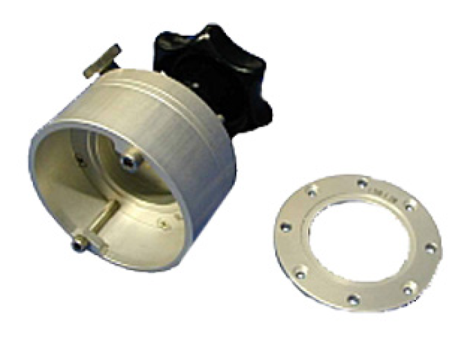 Round aluminum holder with black knob next to circular metal plate with holes.