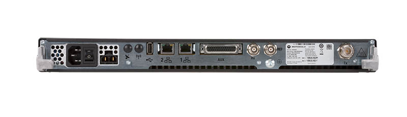 Back of a network device with various ports and a power connector.