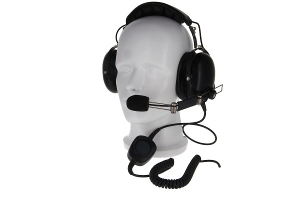 A white head mannequin wearing a black headset with a microphone.