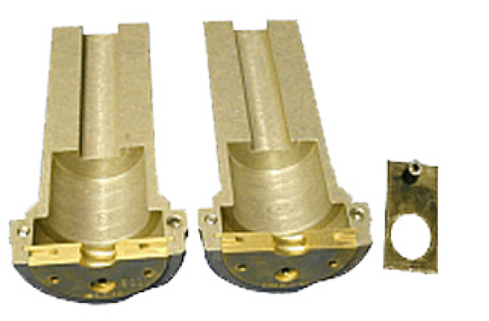 Two gold-colored metal parts with bracket, next to flat rectangular metal piece with hole.