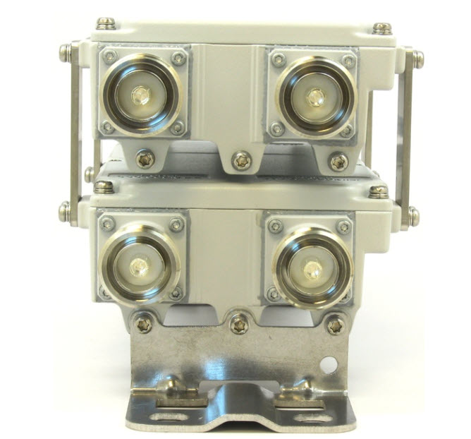 Metal connectors with four ports mounted in two rows.