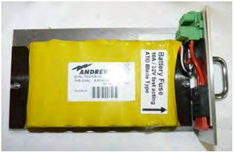 Gele batterij met zekering, draden en connector gemonteerd op een metalen frame.