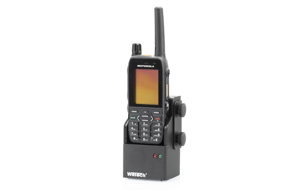 Radioapparaat op laadstation met antenne en toetsenbord.
