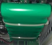 Green capacitor inside an electronic device.