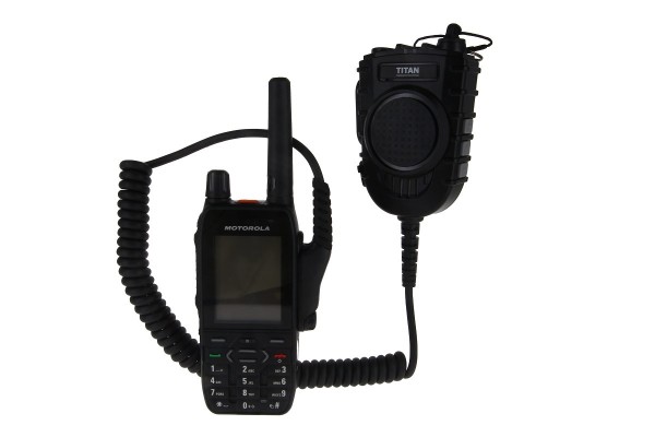Radio device with microphone, connected by coiled cable.