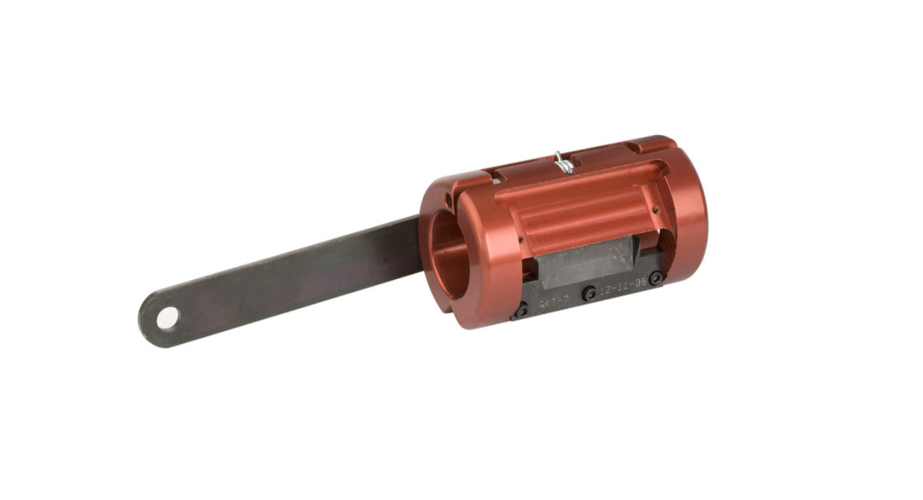 Red mechanical component with long black arm and screws.