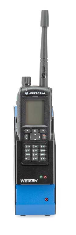 A Motorola radio in a blue charging station.