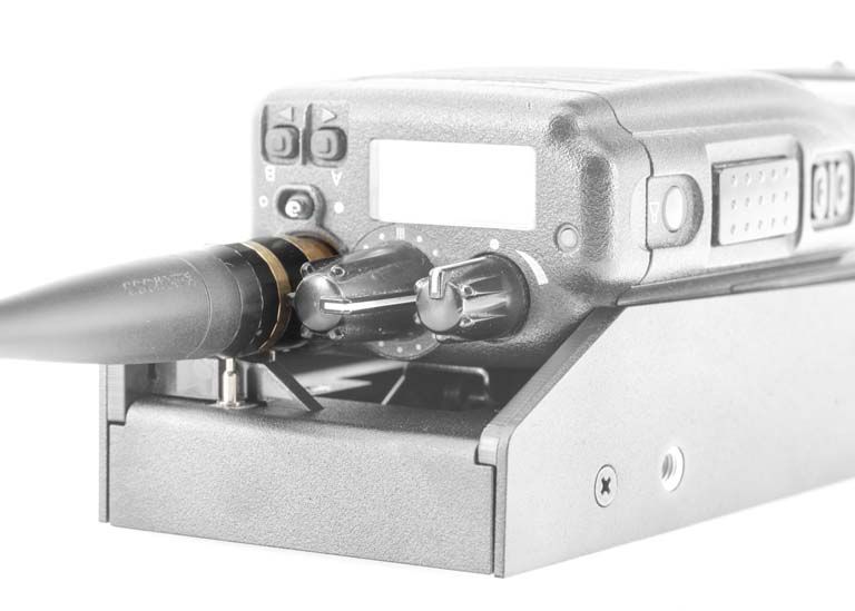 Soldering iron in stand, illuminated handheld device.