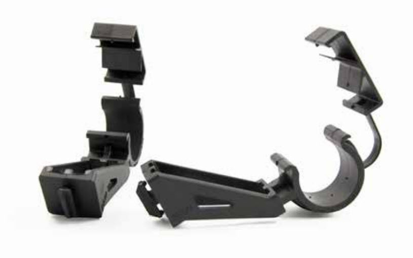 Two black plastic clamps, open and standing apart.