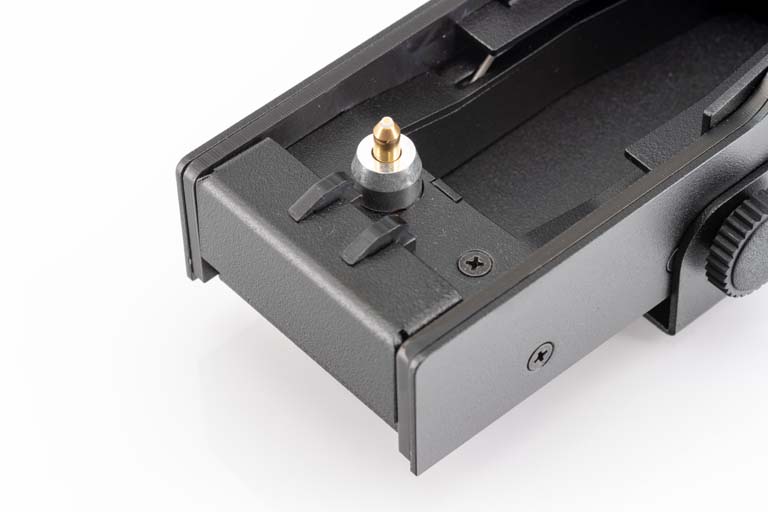 Detail van een elektrisch accessoire met zwarte behuizing en gouden contact.
